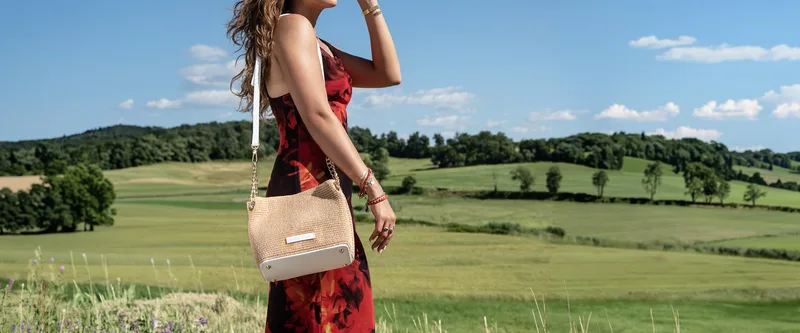 A woman with a Tuscany Leather bag in the Italian countryside