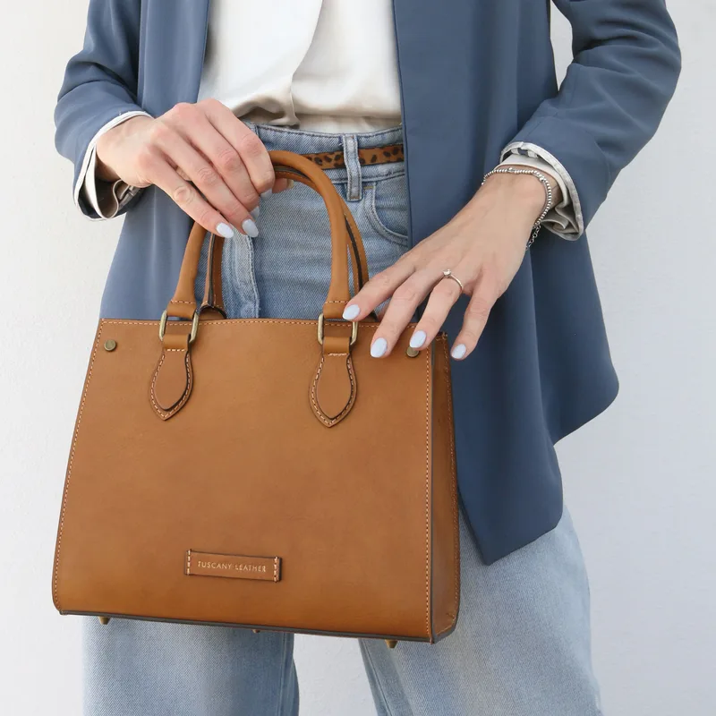 Woman holding a Tuscany Leather handbag